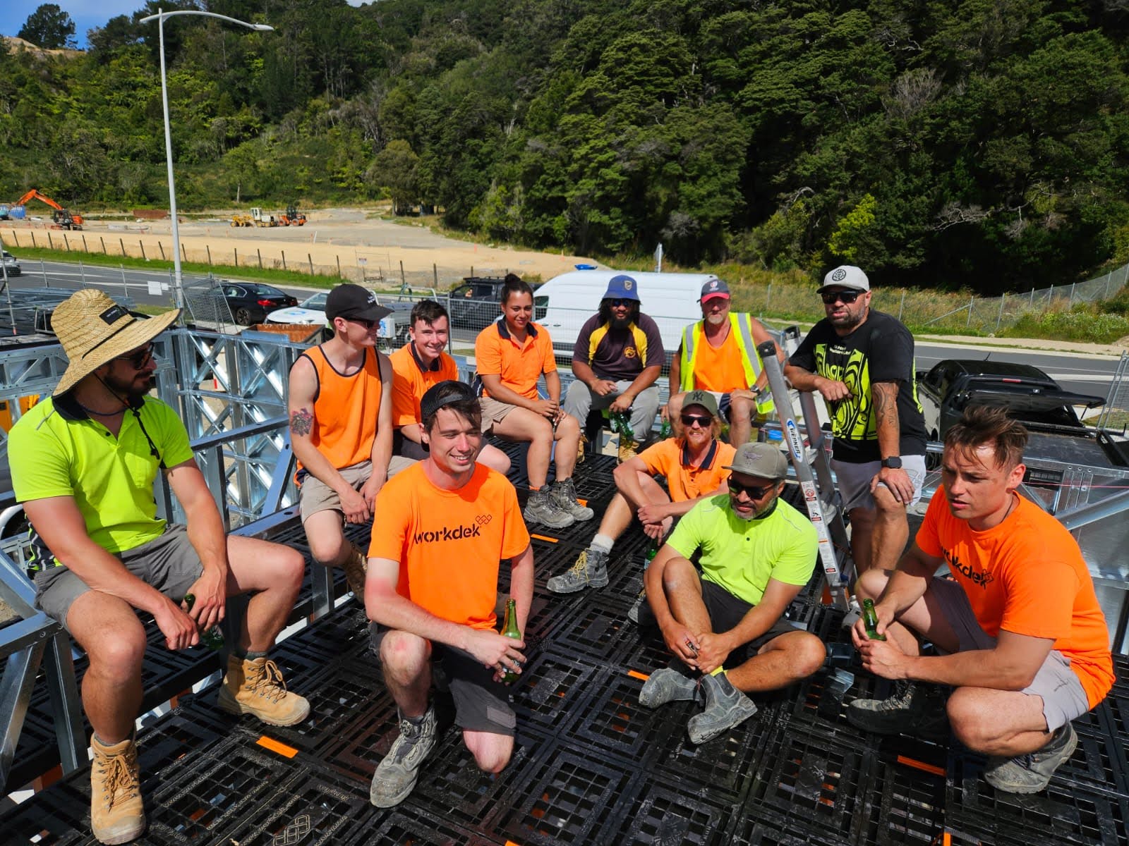 Workdek team and partners sitting together on a Workdek platform at a residential construction site